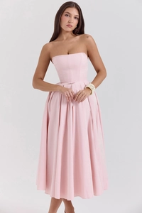 Detail of light pink strapless midi dress featuring pleated skirt and structured bodice