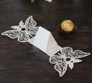 Macro detail of white laser-cut butterfly candy box with elegant hollowed-out wings