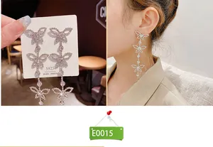 Detailed view of silver butterfly tassel earrings with S925 needles on a model's ear