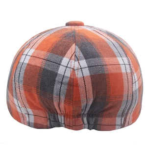 Detailed back view of orange plaid newsboy cap showing elastic band for adjustable fit