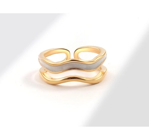 Detail of a gold-plated double-layer wavy ring with grey enamel inlay and open band