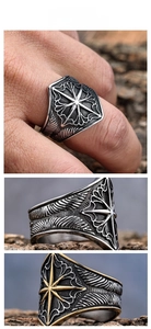 Macro shot of Viking octagram star ring with vintage engraved feather texture details