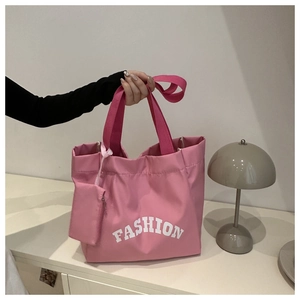 Detailed view of pink Oxford tote bag with small matching pouch and Fashion slogan