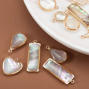 Natural mother of pearl shell charms with gold plated borders in heart and drop shapes