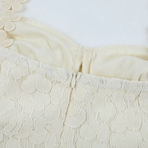 Detail shot of cream lace embroidery and invisible zipper on the elegant dress