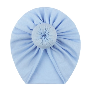 Soft light blue baby donut beanie hat made of cotton blend with central decorative knot