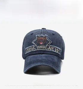 Detail of vintage washed denim baseball cap with navy blue embroidery and retro patch