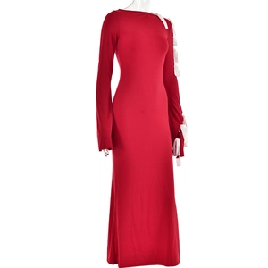Detail of red off-shoulder dress featuring white fringe tassels on the sleeves