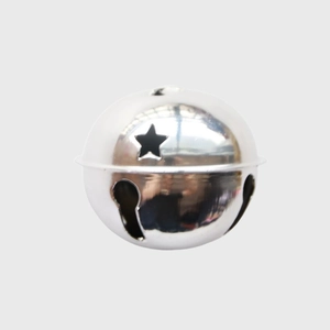 Close-up of a shiny silver 8cm metal Christmas bell with star and keyhole cutouts