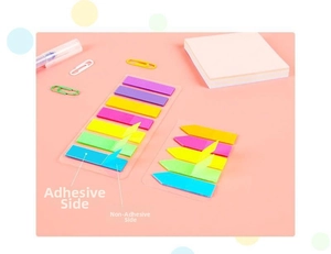 Detailed view of colorful translucent PET index tabs on a pink desk with office stationery