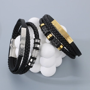 Close-up of men's braided leather bracelet with magnetic clasp and steel texture