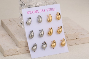 Macro view of teardrop stud earrings set in gold and silver stainless steel