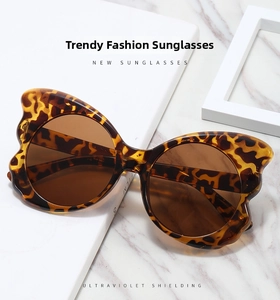 Detail of tortoise butterfly sunglasses with UV protection on marble surface