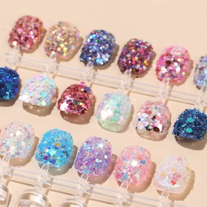 Glitter nail art kit with colorful hexagonal sequins on display tips in multiple shades