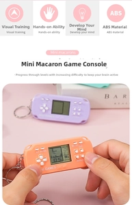 Close-up of a mini Tetris handheld game console with keychain in macaron colors