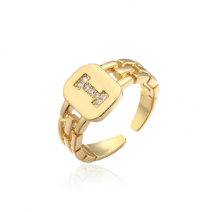 Close-up of golden adjustable ring featuring a micro-paved zircon letter H on square face