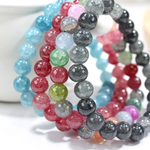 Detailed close-up of colorful cracked crystal beads showing unique texture and vibrant patterns