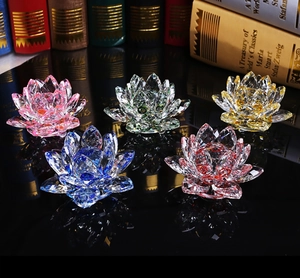 Five assorted colorful crystal lotus flowers in a decorative arrangement on dark reflection