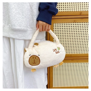 Close-up of plush Capybara backpack with embroidered text on a soft wood background
