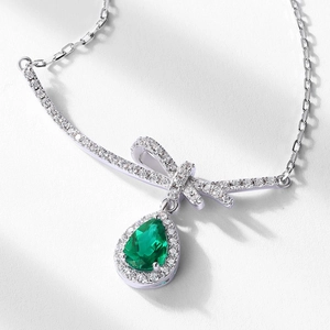 S925 silver bow necklace with pear-shaped lab-grown emerald and sparkling zircon accents