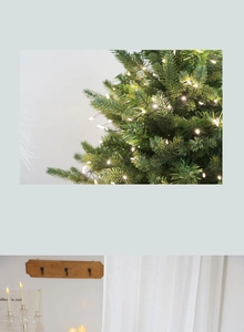 Close-up of warm white LED string lights on a green Christmas tree for festive decor