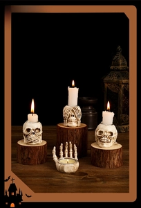 Detail of four-piece skull candle holders including hear-no-see-no-speak-no evil and palm tray