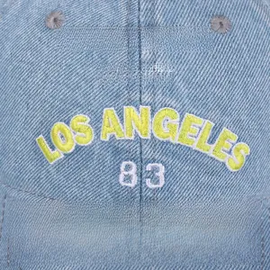 Close-up of Los Angeles 83 3D embroidery on washed blue denim baseball cap