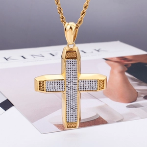 Macro shot of hip hop cross pendant with clear crystals on a gold rope chain