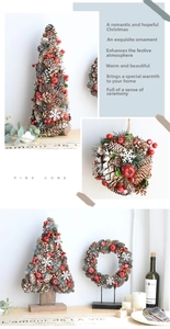 Detail of Christmas decoration with natural pine cones, red berries and snow accents