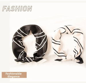 Detail of silk-texture square scarves with geometric patterns in black and white styles