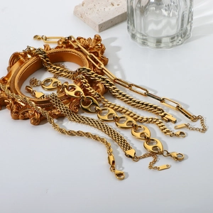 Layered 18K gold stainless steel bracelets with Cuban and snake chain links on a frame