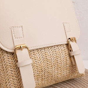 Straw and PU leather contrast woven backpack featuring gold metal buckle and stitch detail