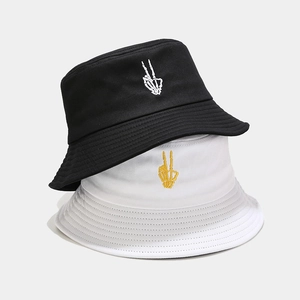 Cotton bucket hats in black and white featuring skeletal finger embroidery for a trendy look