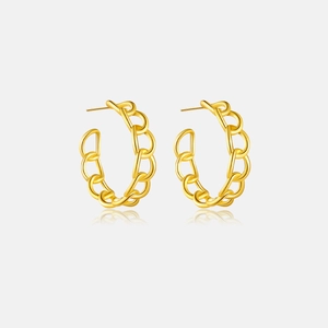 Detailed close-up of golden C-shaped chain link earrings with high-polished metal finish