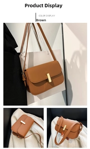 Detailed view of the brown leather saddle bag featuring a gold rectangular metal lock