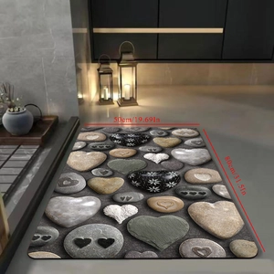 Detail view of heart shaped pebble bath mat with 3D effect in gray and earthy tones