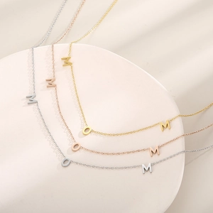 Three MOM pendant necklaces in silver, rose gold, and gold plated stainless steel