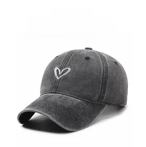 Detailed macro view of the distressed grey cotton fabric and white heart embroidery