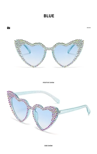 Detail view of heart-shaped rhinestone sunglasses with blue glitter frames and light blue lenses