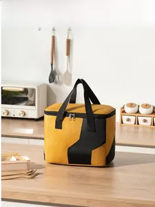 Detail of insulated lunch bag with vibrant yellow and black splicing and sturdy handles