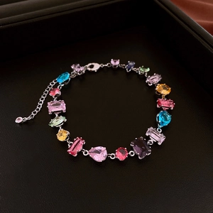 Detailed close-up of multi-color gemstone bracelet with lobster clasp and adjustable chain