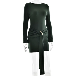 Detail of dark green mini dress featuring side ruching and a gold ring buckle with sash