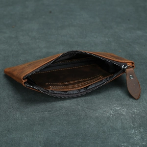 Macro shot of brown vintage leather wallet detailing smooth zipper and internal card slots