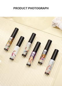 Set of six colorful waterproof mascaras with vintage illustration tubes on a glass tray