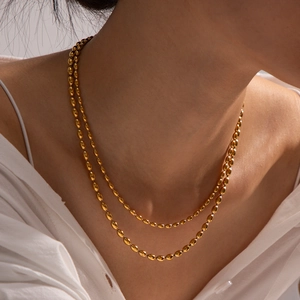 Golden double layer stainless steel bead chain necklace for women on model neck