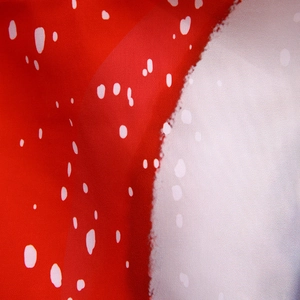 Detail shot of the fabric texture and red and white polka dot print of the Christmas apron
