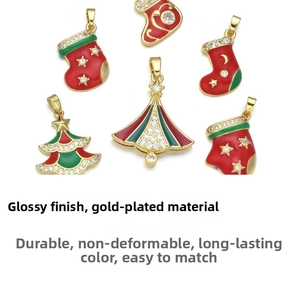 Detail of gold-plated Christmas charms with red and green enamel and sparkling zircons