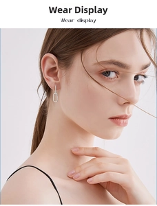 Close-up of geometric S925 silver moissanite drop earrings on a female model