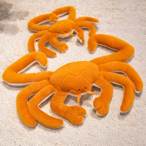 Soft orange king crab plush toy set in two sizes on a cozy white carpet for home decor