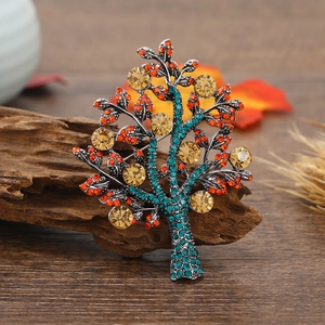 Vintage Tree of Life brooch with champagne crystals and green rhinestones on aged wood